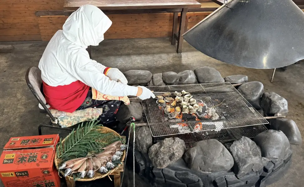 Ama Divers: An Ama Diver cooking oysters