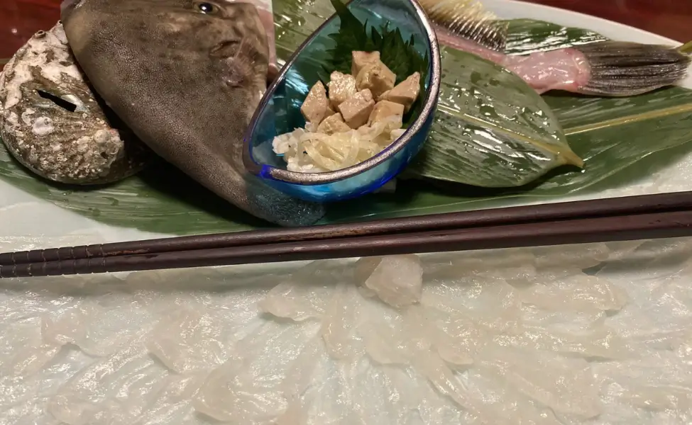 This sashimi dish features Kawahagi (filefish) with its liver, served in a traditional ikizukuri style This sashimi dish features Kawahagi (filefish) with its liver, served in a traditional ikizukuri style