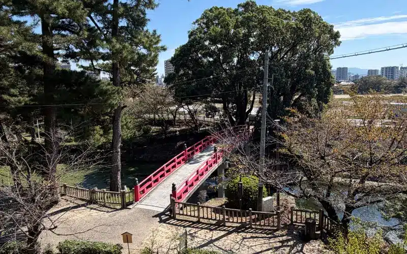 A red bridge crossing the moat in the grounds of Okazaki Castle A red bridge crossing the moat in the grounds of Okazaki Castle